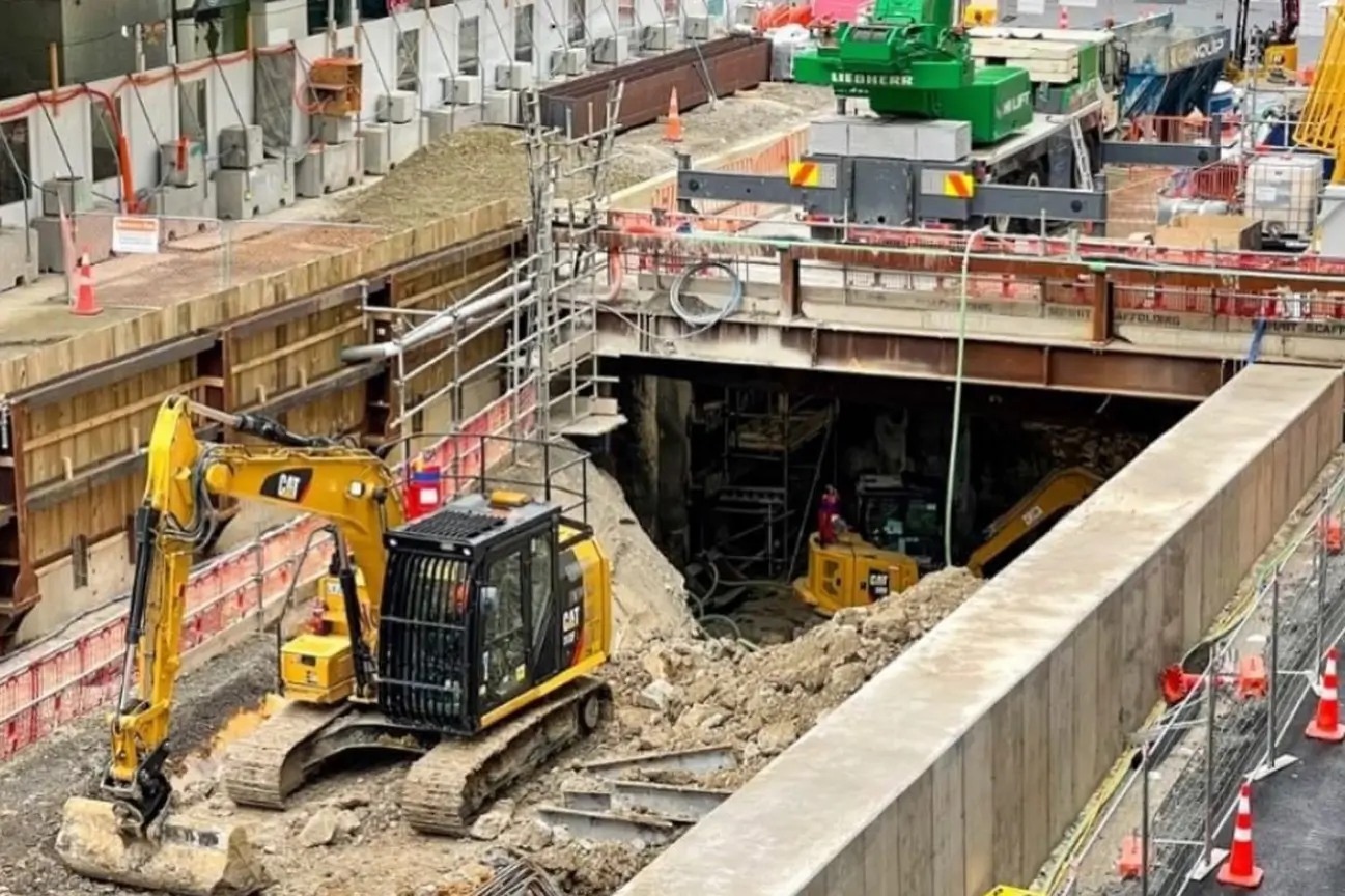 Heavy excavator performing controlled site breaking and concrete removal for CB Earthmoving Northland demolition projects.